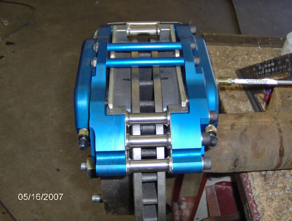 Blue brake caliper assembly with stainless steel hardware and brake pads