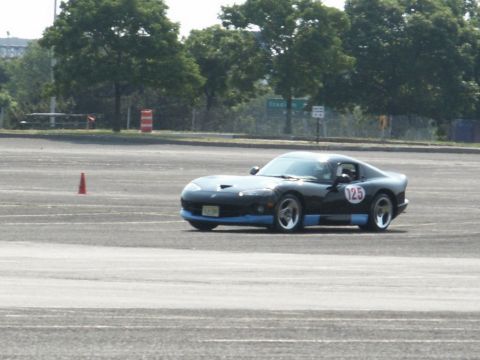 2001 Mercury Grand Marquis - A black Dodge Viper with blue trim and race number 125 is seen on a track.