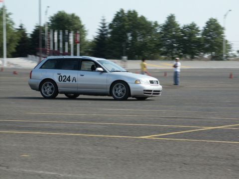 2001 Mercury Grand Marquis - A silver station wagon is seen on a paved track with orange cones in the background.