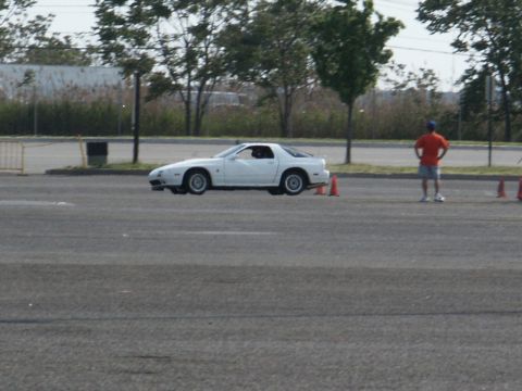 2001 Mercury Grand Marquis - White Mazda RX-7 sports coupe seen from the side on an asphalt lot with orange cones.