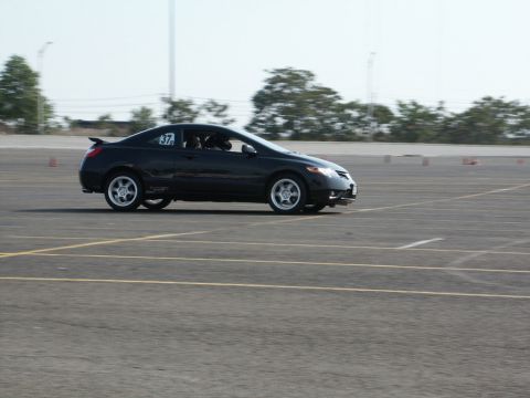 2001 Mercury Grand Marquis - A black coupe with racing number 37 on its door is seen on a track during an event.