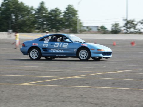 2001 Mercury Grand Marquis - A blue Toyota MR2, number ES-312, navigates a course marked by orange cones.