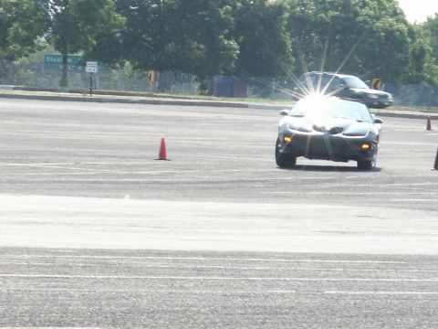 2001 Mercury Grand Marquis - A Pontiac Firebird navigates a course marked by cones, with another vehicle visible in the background.