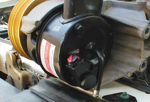 1996 Ford Bronco - Close-up of a power steering pump and pulley assembly, likely from an older vehicle.