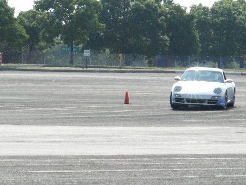 2001 Mercury Grand Marquis - A white sports car navigates a course marked by an orange cone.