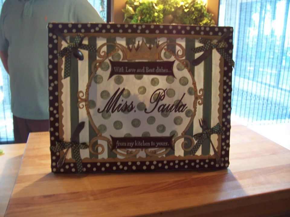 Decorative striped 'Miss Paula' recipe box on a wood table