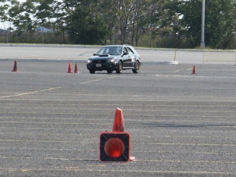 2001 Mercury Grand Marquis - A Subaru Impreza WRX wagon navigates a cone course on a sunny day.