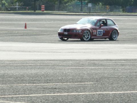 2001 Mercury Grand Marquis - A red BMW Z3 coupe navigates a track, displaying the number 737 on its side.