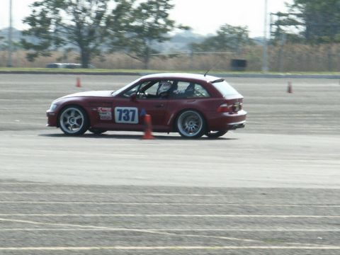 2001 Mercury Grand Marquis - A red coupe with racing number 737 is seen on a track, possibly during a race event.