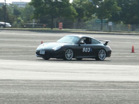 2001 Mercury Grand Marquis - A black Porsche 911 is seen on a track, marked with the number 903A and surrounded by orange cones.
