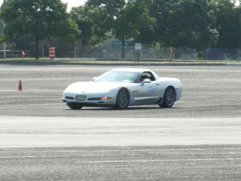 2001 Mercury Grand Marquis - A white Chevrolet Corvette C5 is seen on a paved surface, possibly during a track event.
