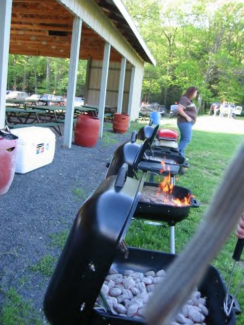 1991 Ford Bronco - An outdoor gathering with grills being used for cooking, set in a park-like environment.