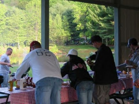 1991 Ford Bronco - Outdoor gathering with people enjoying food and drinks by a lake.