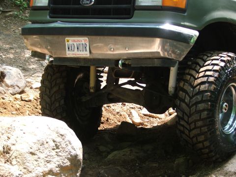 1996 Ford Bronco - The front of a 1996 Ford Bronco navigates a rocky off-road path.