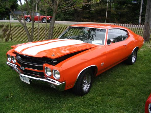 1993 Ford Taurus - 1970 Chevrolet Chevelle SS on display at a car show, with another car visible in the background.