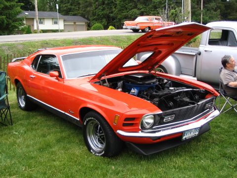 1993 Ford Taurus - This orange 1970 Ford Mustang Mach 1 is displayed with its hood open at a car show.