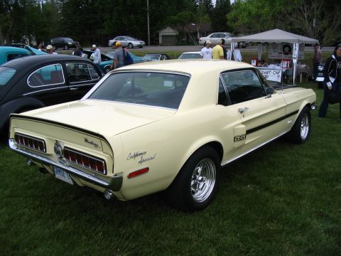 1993 Ford Taurus - Yellow 1968 Ford Mustang California Special GT/CS at a car show.
