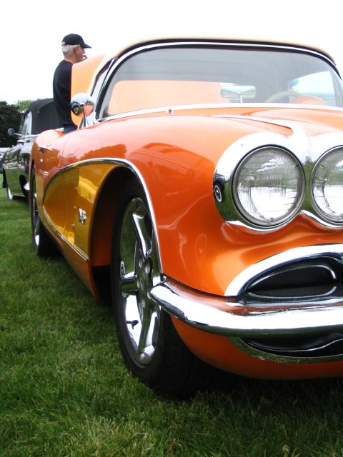 1993 Ford Taurus - Close-up of an orange classic car's front end, showing its distinctive grille and headlights.
