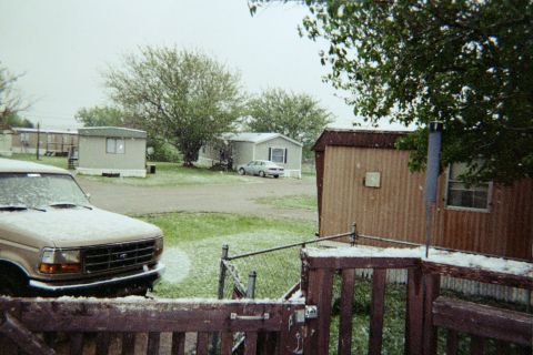 1996 Ford Bronco - A tan Ford F-Series truck is parked in a snowy mobile home park.