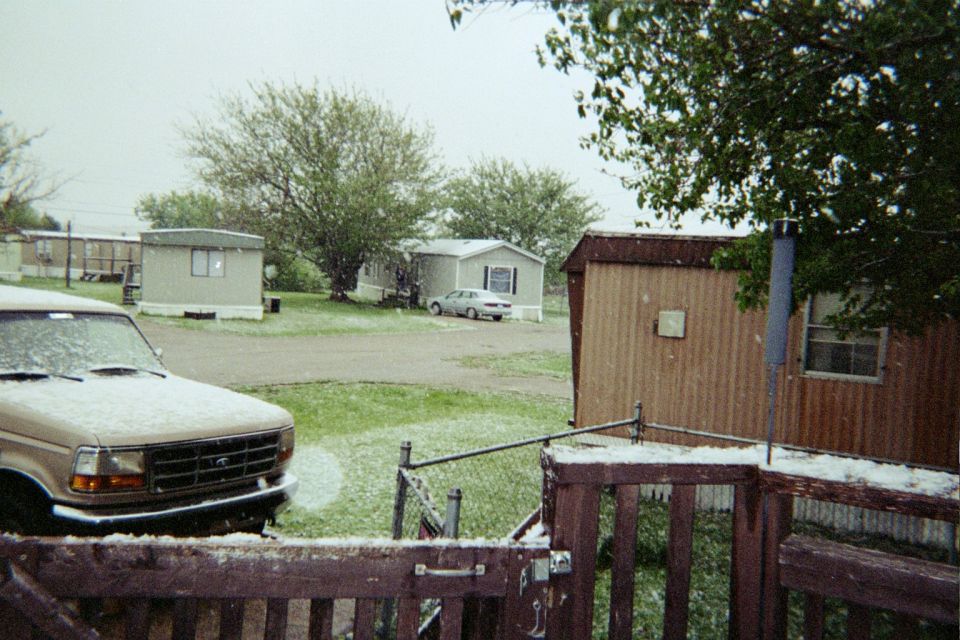 Tan Ford F-Series truck front view, covered in snow