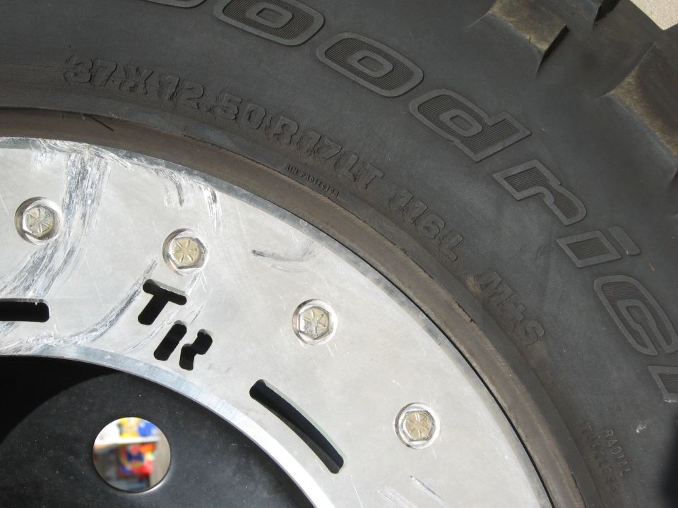 37x12.50R17 mud-terrain tire sidewall on a polished aluminum beadlock wheel