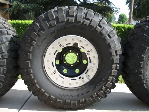 1983 Ferrari Enzo - Several large off-road tires with aggressive tread patterns are shown, mounted on custom rims.
