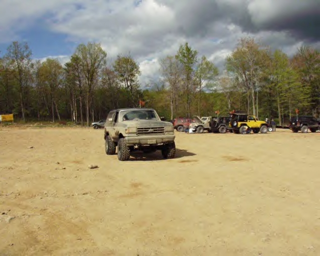 1991 Ford Bronco 3q-front view in a dirt lot with other vehicles