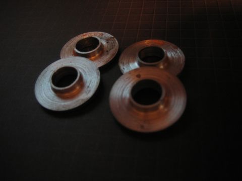 2001 Jeep Wrangler - Four metallic washers are shown in close-up on a dark, textured background.
