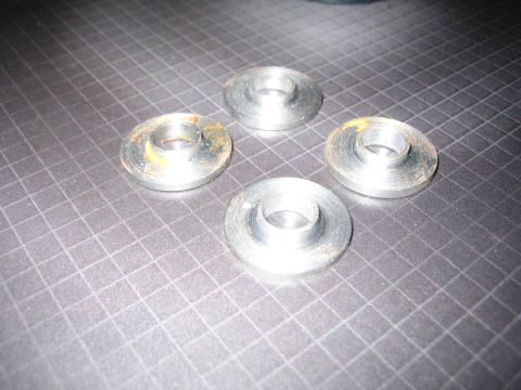 2001 Jeep Wrangler - Four metal washers are shown on a grid-patterned surface, with some signs of rust.