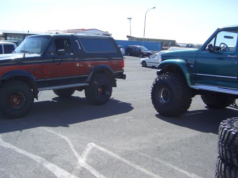 1996 Ford Bronco - This 1996 Ford Bronco is parked next to another modified SUV on a sunny day.