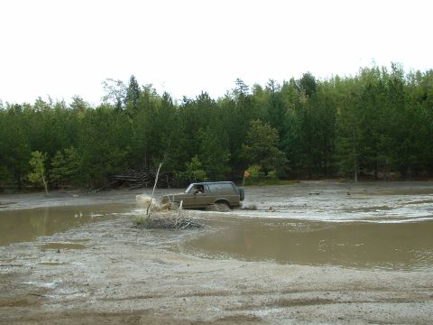 1991 Ford Bronco - This 1991 Ford Bronco is navigating through a challenging muddy terrain.