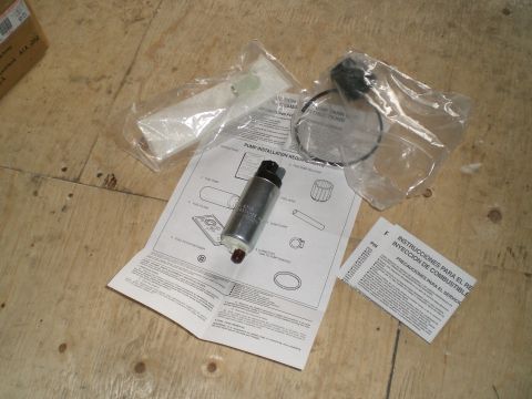 1995 Ford Probe - Fuel pump and installation instructions are displayed on a wooden surface.