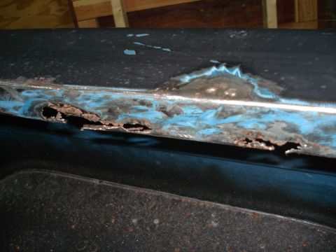 1979 Chevrolet C/K Pickup - This panel shows significant rust damage, with holes exposing the blue primer underneath.