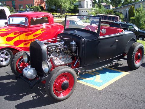 1972 Ford Ranchero - A custom hot rod roadster sits parked on a sunny day, with another classic car visible to its left.