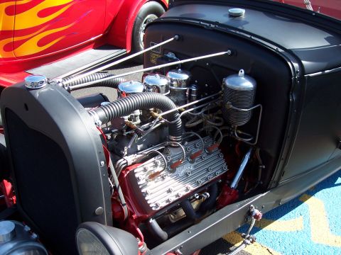 1972 Ford Ranchero - Close-up of a hot rod's engine bay, with a red car flame graphics visible in the background.