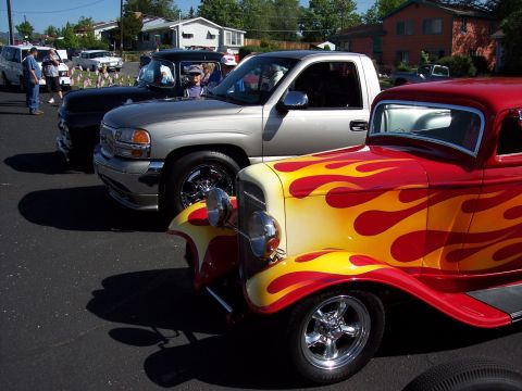 1972 Ford Ranchero - A classic hot rod with flame graphics is parked in a line with other vehicles.