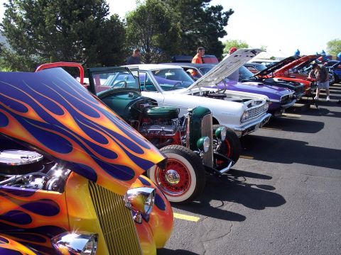 1972 Ford Ranchero - Several custom and classic cars are lined up with their hoods open, displaying their engines at an outdoor event.