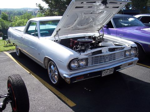1972 Ford Ranchero - A white 1964 Ford Ranchero is parked with its hood open, next to a purple car.