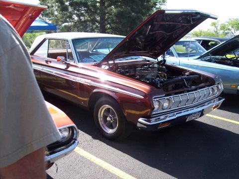 1972 Ford Ranchero - A red pickup truck from the 1970s is displayed with its hood open at an outdoor event.