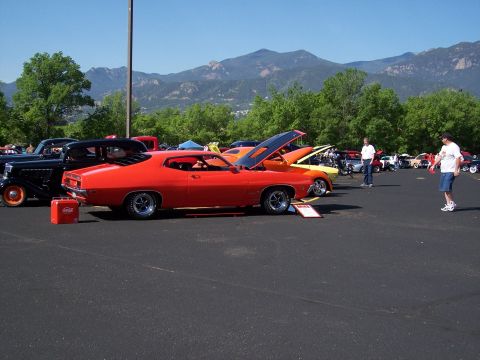 1972 Ford Ranchero - Red 1972 Ford Ranchero seen at an outdoor event with mountains in the background.