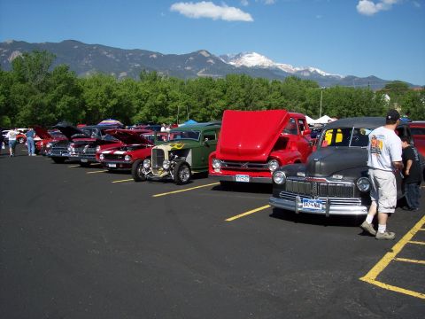 1972 Ford Ranchero - A variety of vintage vehicles are displayed at an outdoor car show under a clear blue sky.
