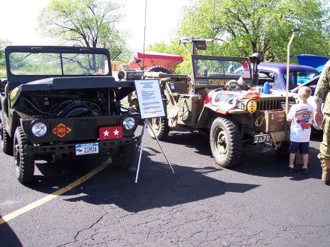 1972 Ford Ranchero - Two vintage military jeeps are displayed outdoors, with one showing its engine and the other adorned with various markings.