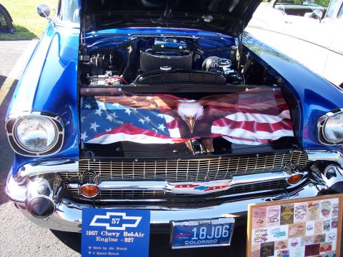 1972 Ford Ranchero - A blue 1957 Chevrolet Bel-Air is displayed with its hood open, revealing the engine and a custom graphic.