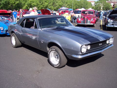 1972 Ford Ranchero - A gray 1967 Chevrolet Camaro SS is parked at an outdoor car show with other vehicles in the background.