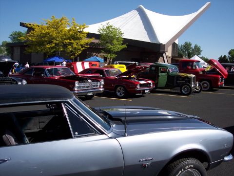 1972 Ford Ranchero - A collection of vintage vehicles are gathered in a parking lot under a clear blue sky.
