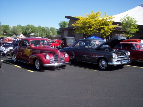 1972 Ford Ranchero - A maroon coupe from the 1940s is parked at an outdoor event with other vehicles.
