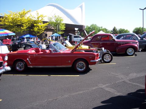 1972 Ford Ranchero - A red convertible is parked at an outdoor event with other classic cars.