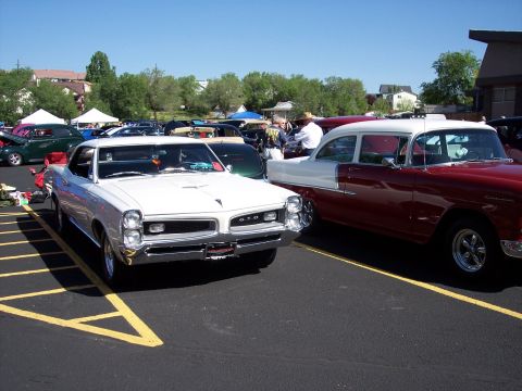 1972 Ford Ranchero - Two classic American cars, a 1966 GTO and a 1955 Chevy, at an outdoor car show.