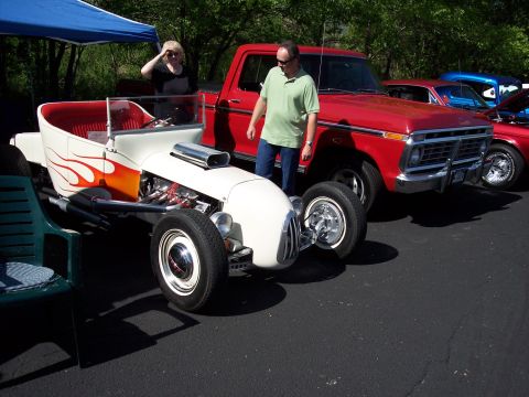 1972 Ford Ranchero - A custom hot rod and a red pickup truck are parked side-by-side at an outdoor event.