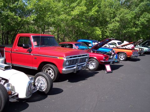 1972 Ford Ranchero - A line of classic vehicles are parked outdoors, with a red 1973 Ford pickup truck in the foreground.